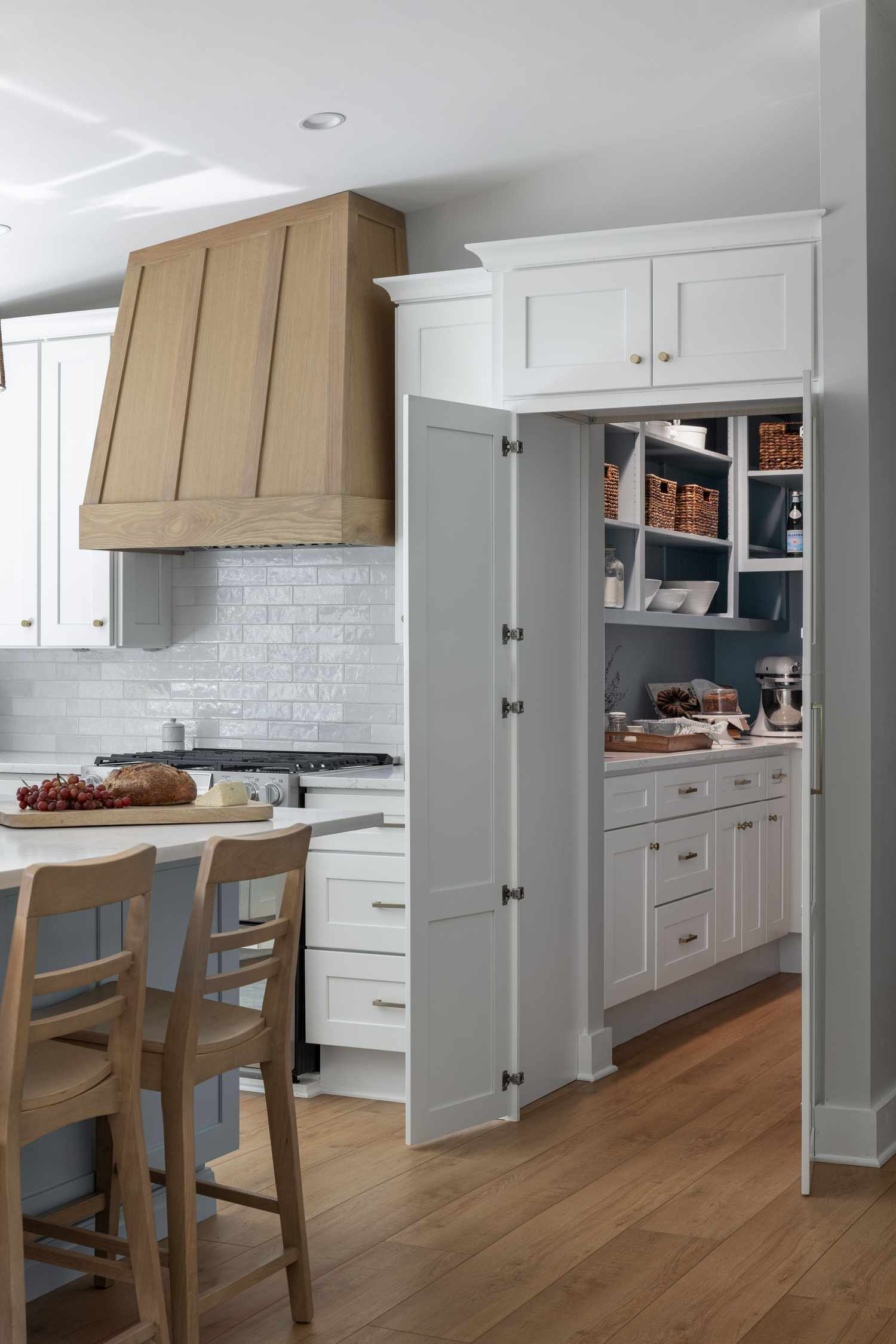 a white kitchen with a hidden pantry
