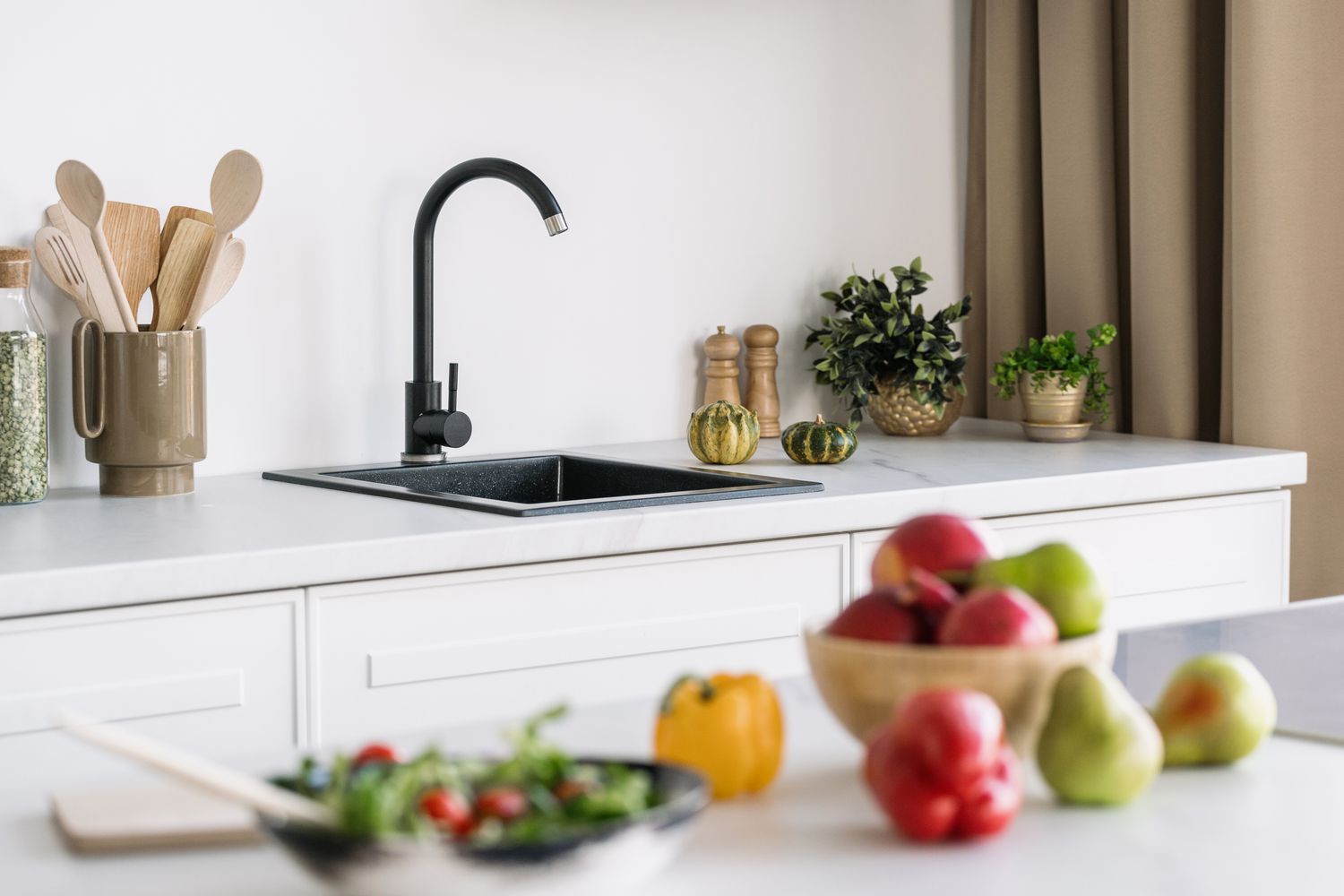 Fruit on counter near kitchen sink 