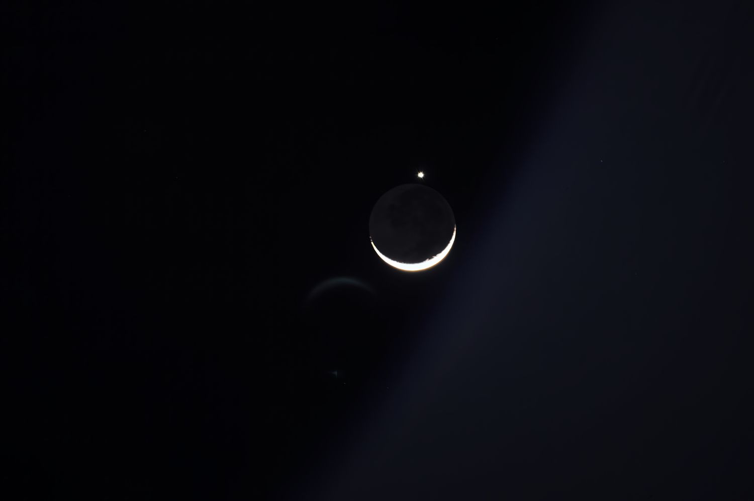 The Moon and Venus shining brightly in the night sky.