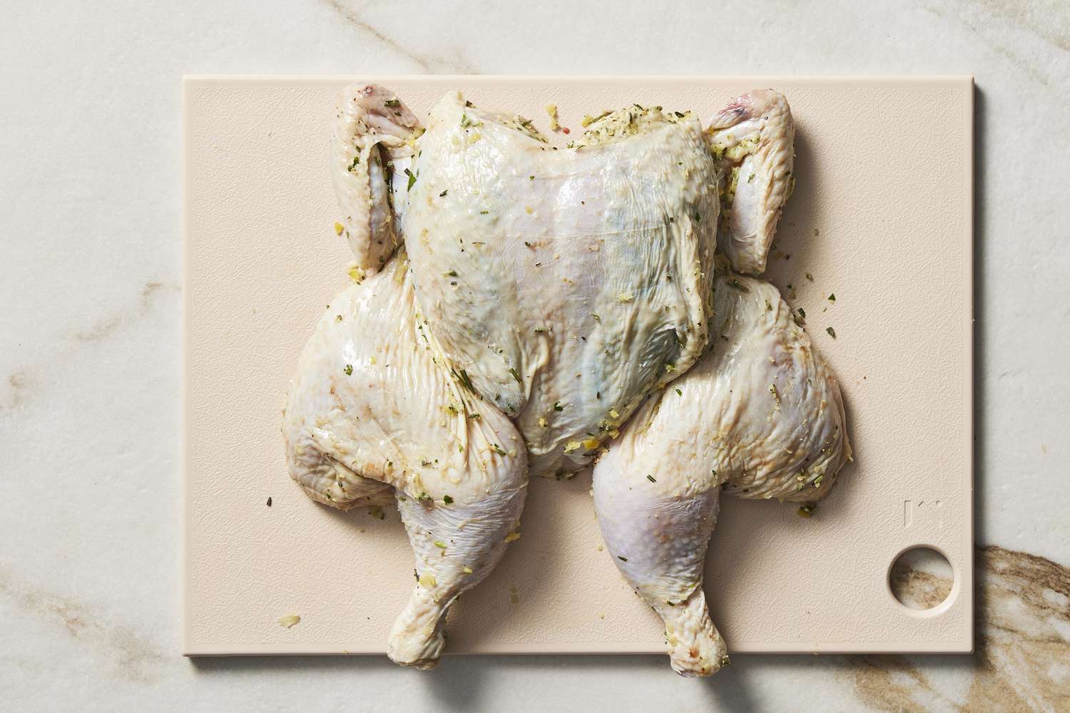 Bare raw spatchcocked chicken