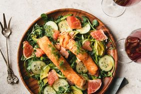Flat lay of slices of Salmon over watercress salad