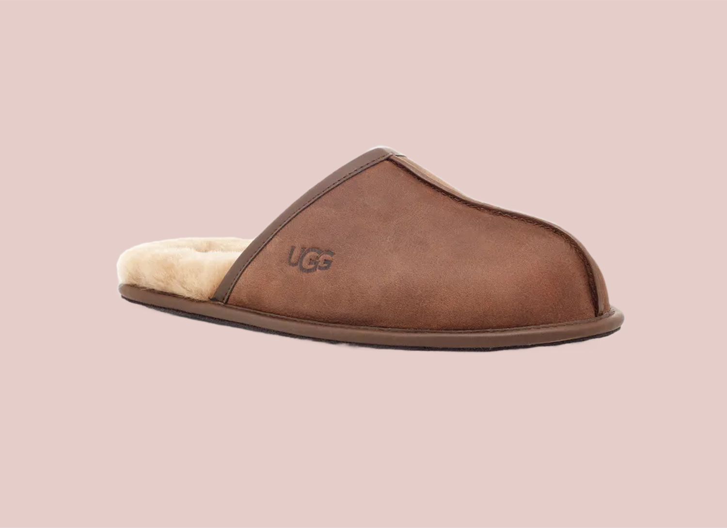 Ugg brown lined slipper on a pink background
