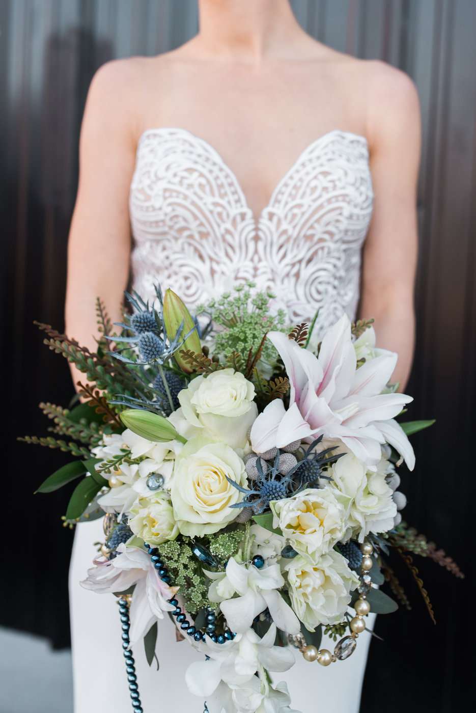 bouquet with trumpet lily thistle and garden roses