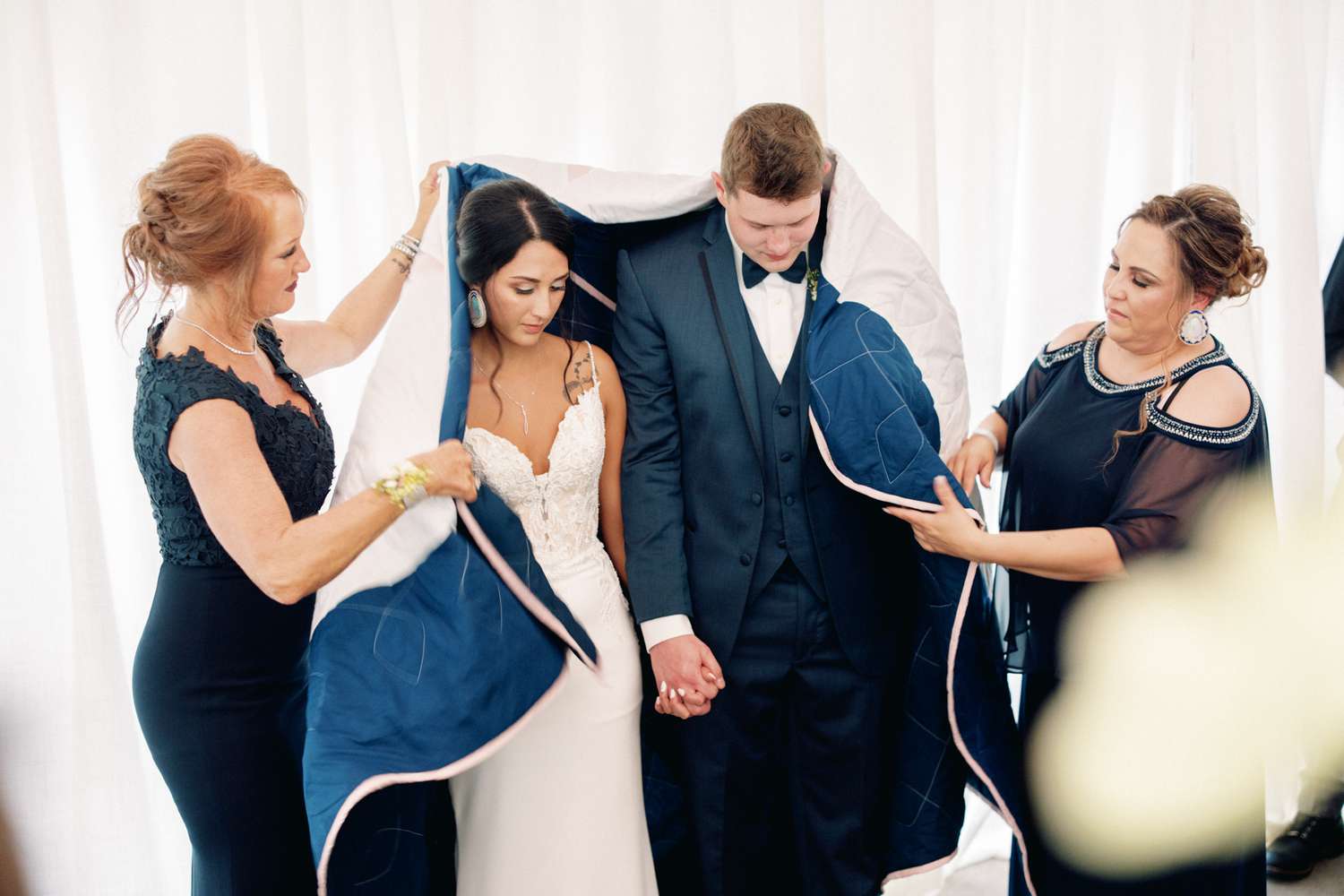 bride and groom wrapped in native american navy star quilt