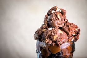 Chocolate ice cream with nuts served in a glass dish