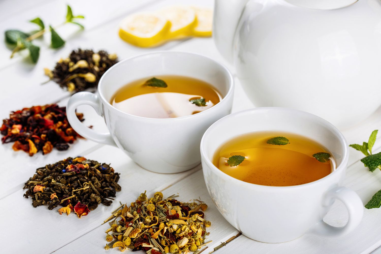 various tea blends with mugs of tea