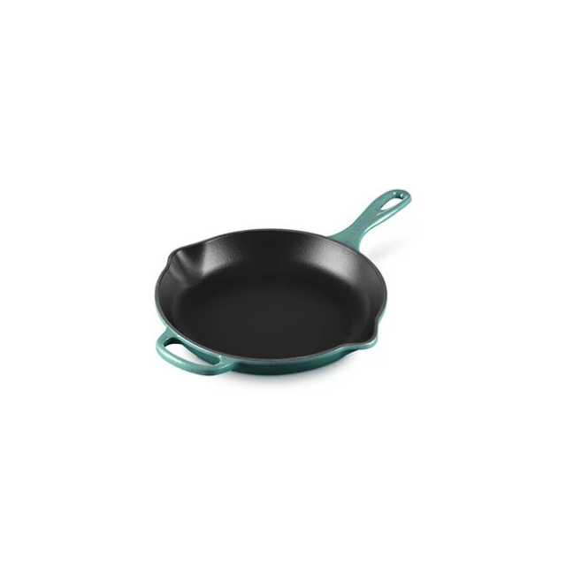 Cast iron skillet with a handle and a helper grip designed for versatile cooking