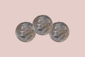 three 1975 dimes on a pale pink background