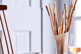 gruyere anchovy and olive straws within glass vase