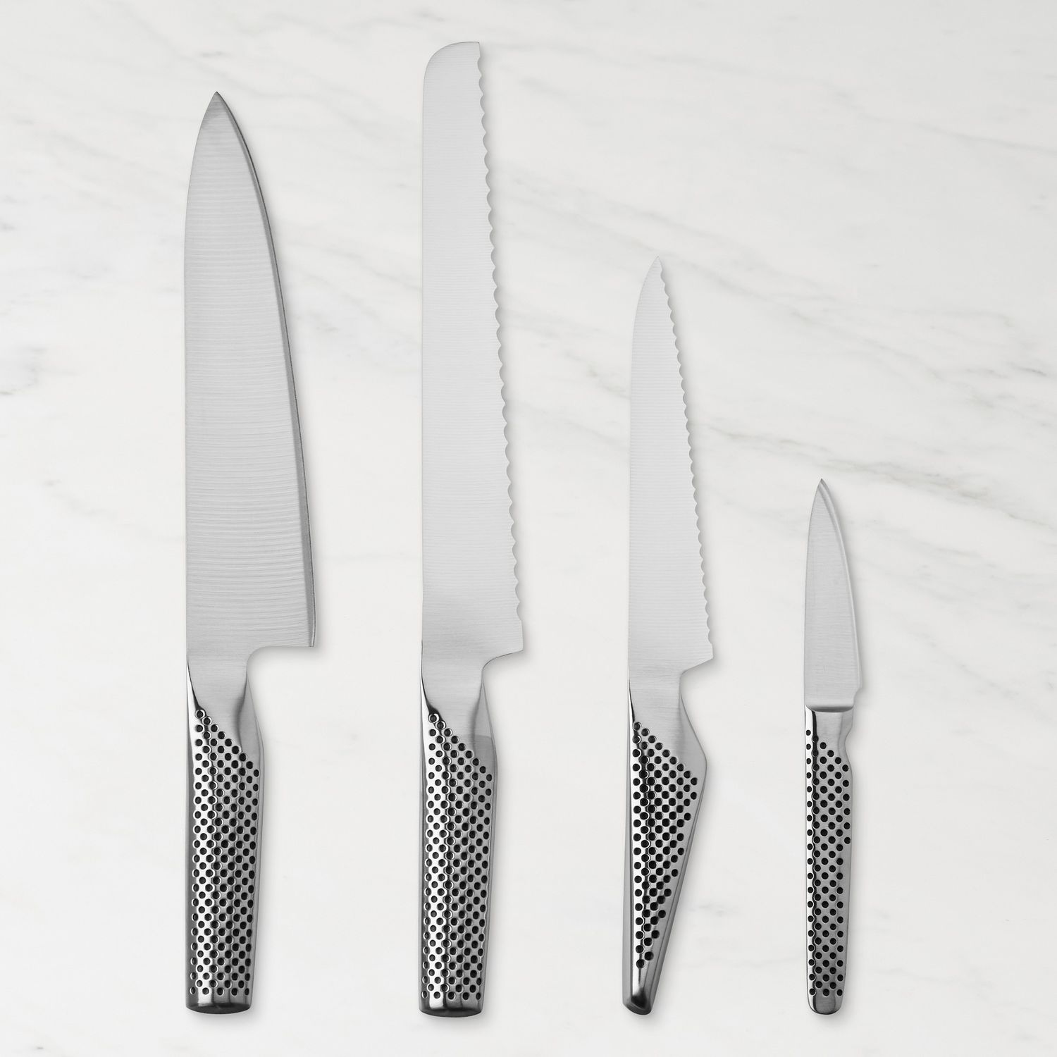 A set of four kitchen knives of varying sizes