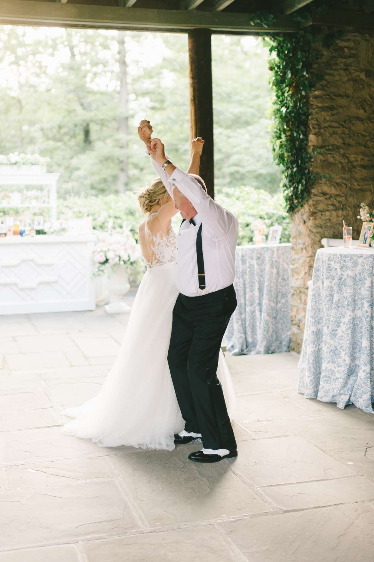 bride and dad dancing on patio at wedding reception