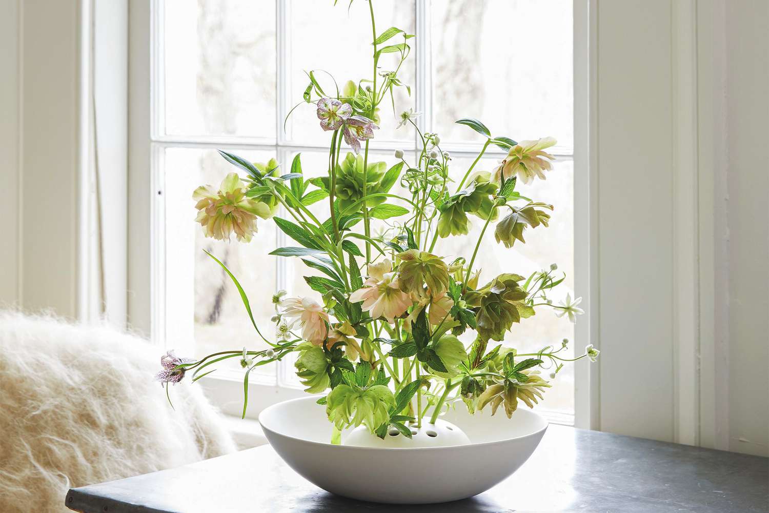 yellow white flowers in frog vase with natural light