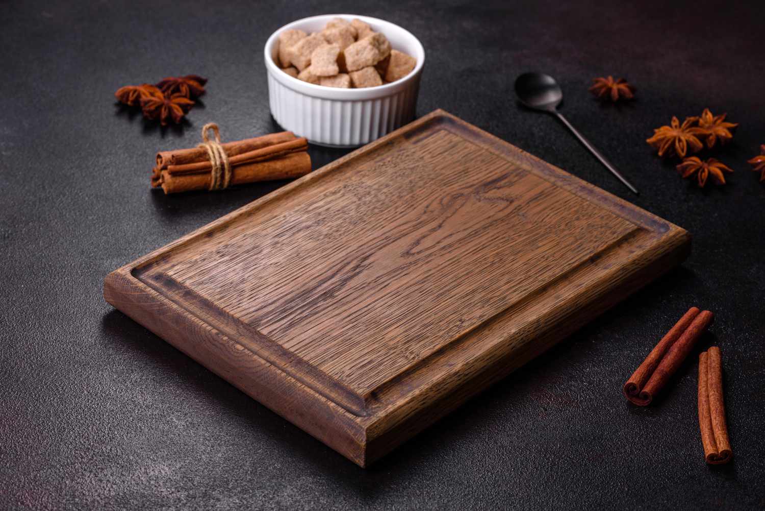 A wood cutting board with cinnamon and sugar 
