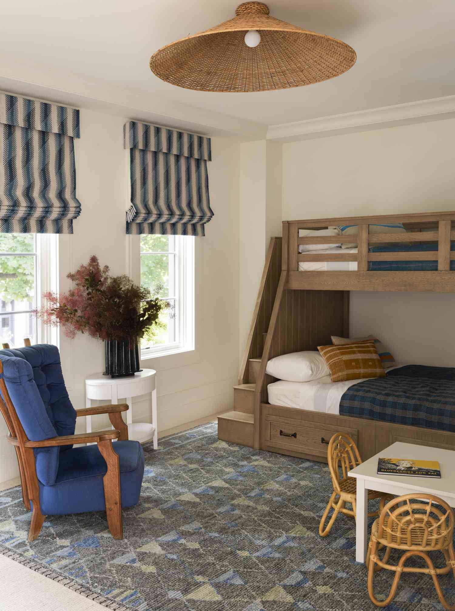 a white bedroom with bunk beds and a rattan flush mount