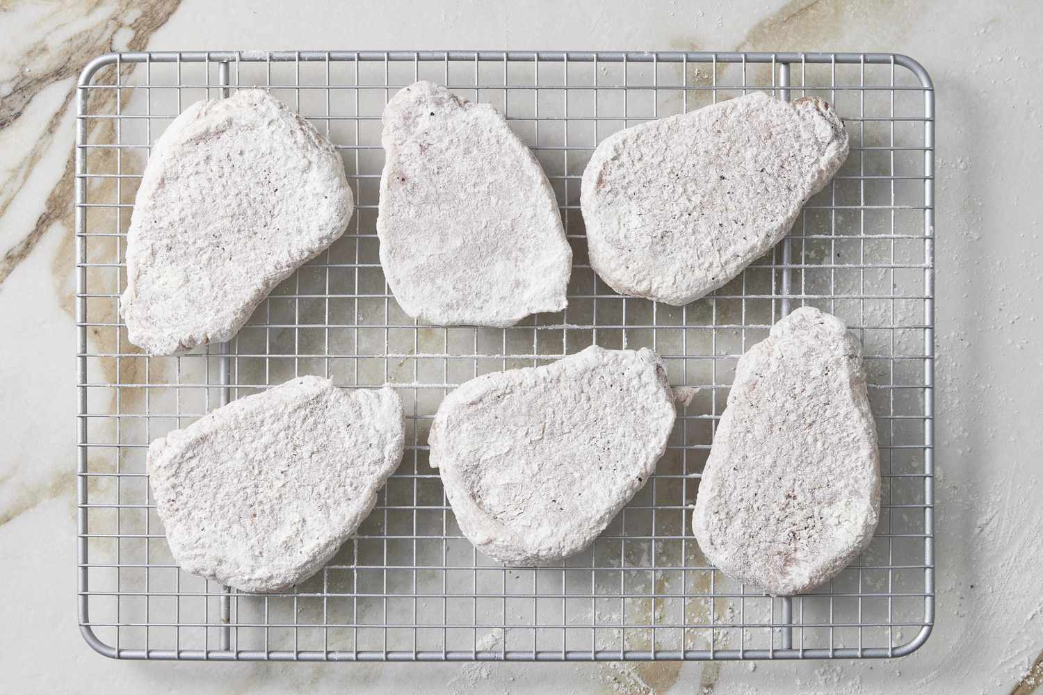 Pork dredged in flour on wire rack