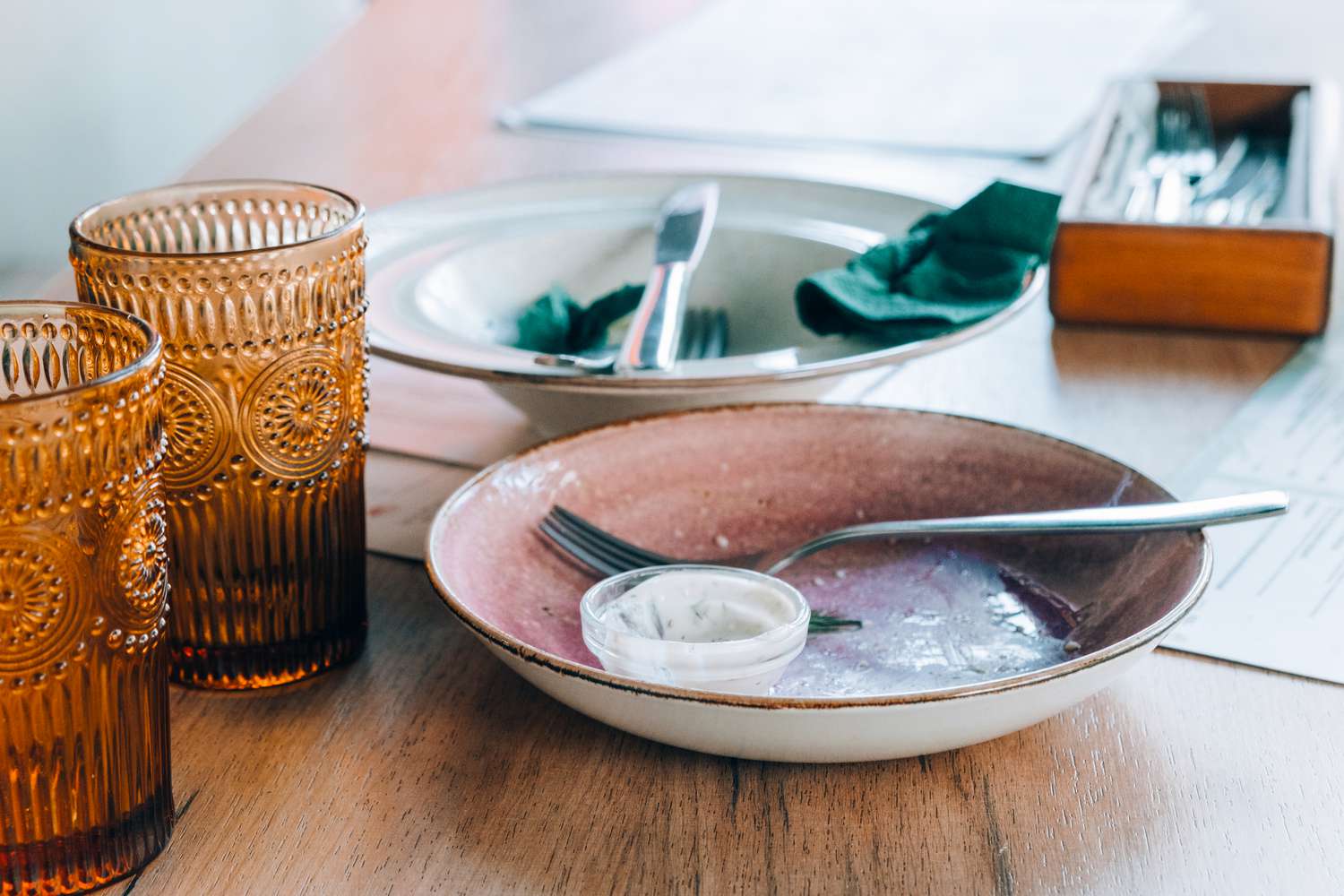 Dirty dishes of leftover food are on the table 