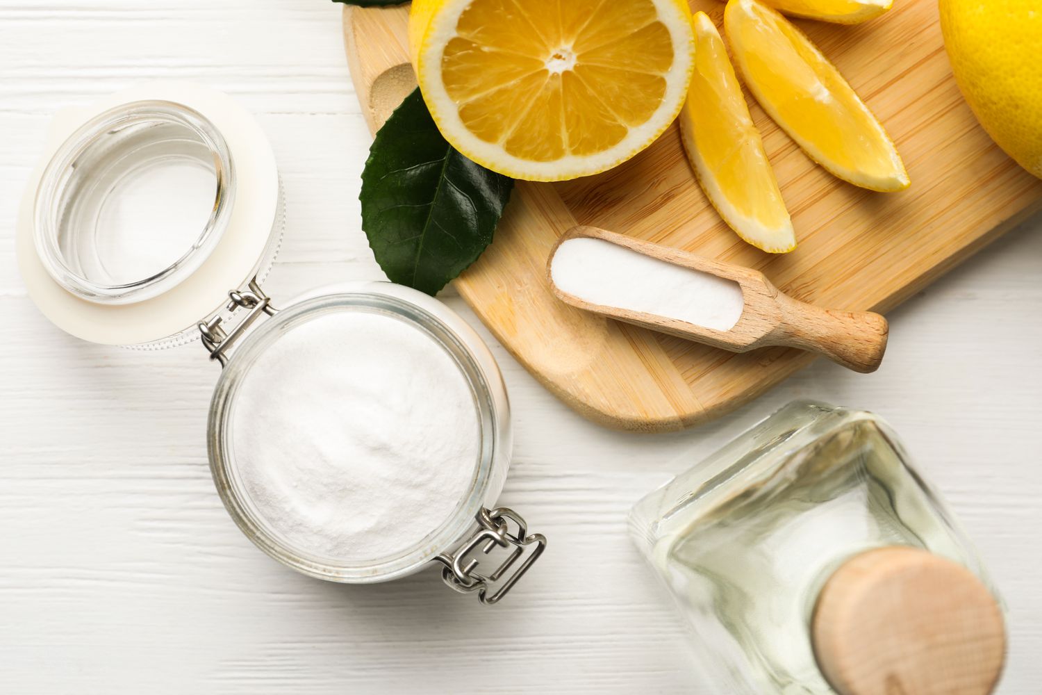 Lemon, baking soda and vinegar for cleaning cutting board