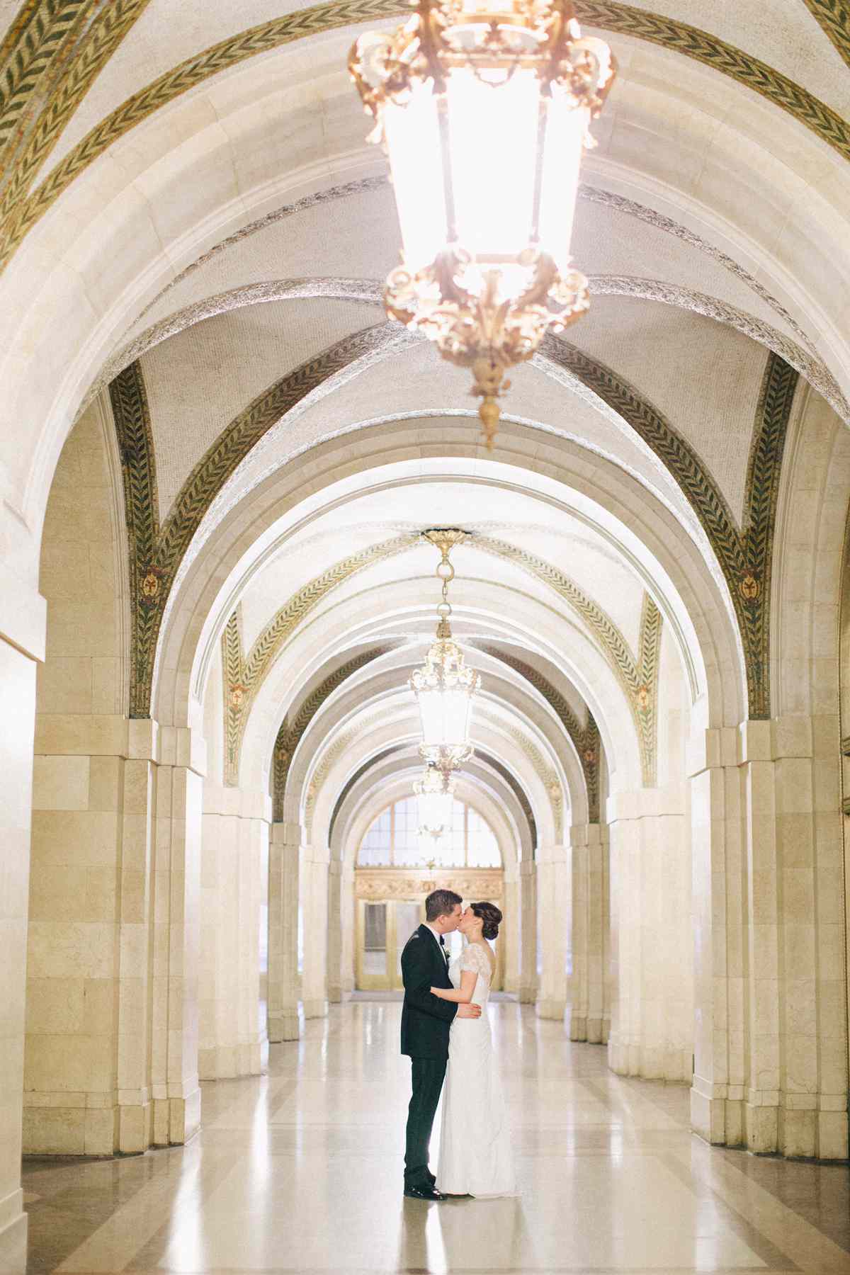 city hall wedding bride and groom kissing in hallway