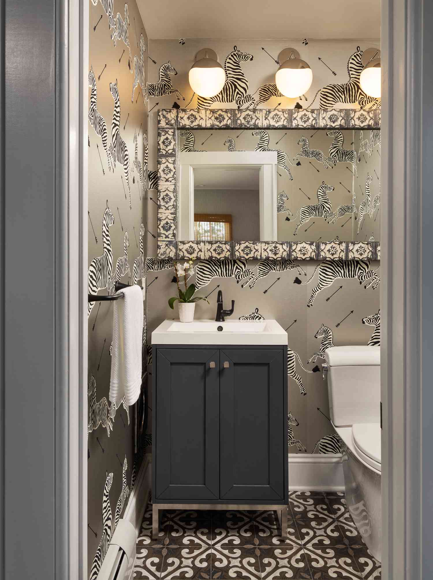silver powder room with zebra print wallpaper motifs