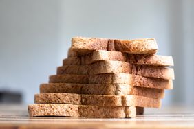 Slices of bread stacked on a counter arranged in a leaning formation