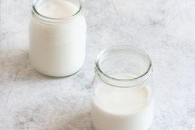 kefir in 2 glass jars on pale surface