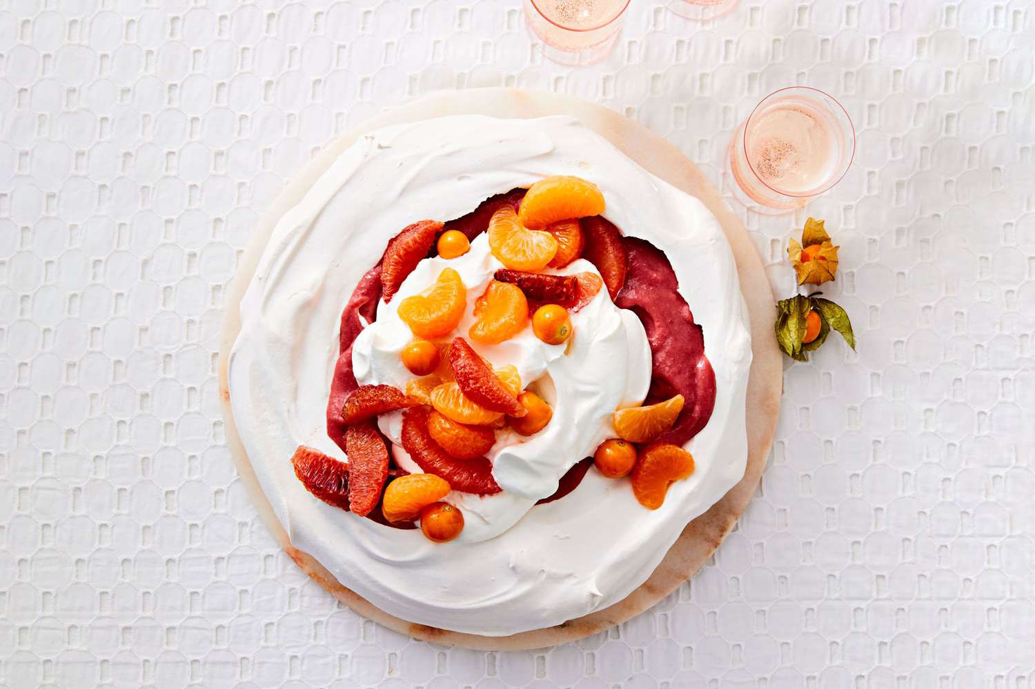 cranberry curd and citrus pavlova with sliced oranges