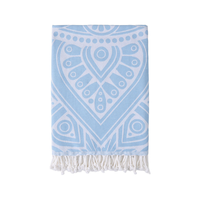 A patterned towel with decorative fringe at the ends