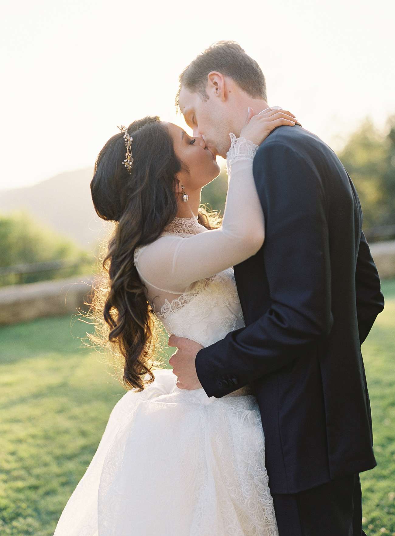 bride and groom kiss for portraits before cocktail hour