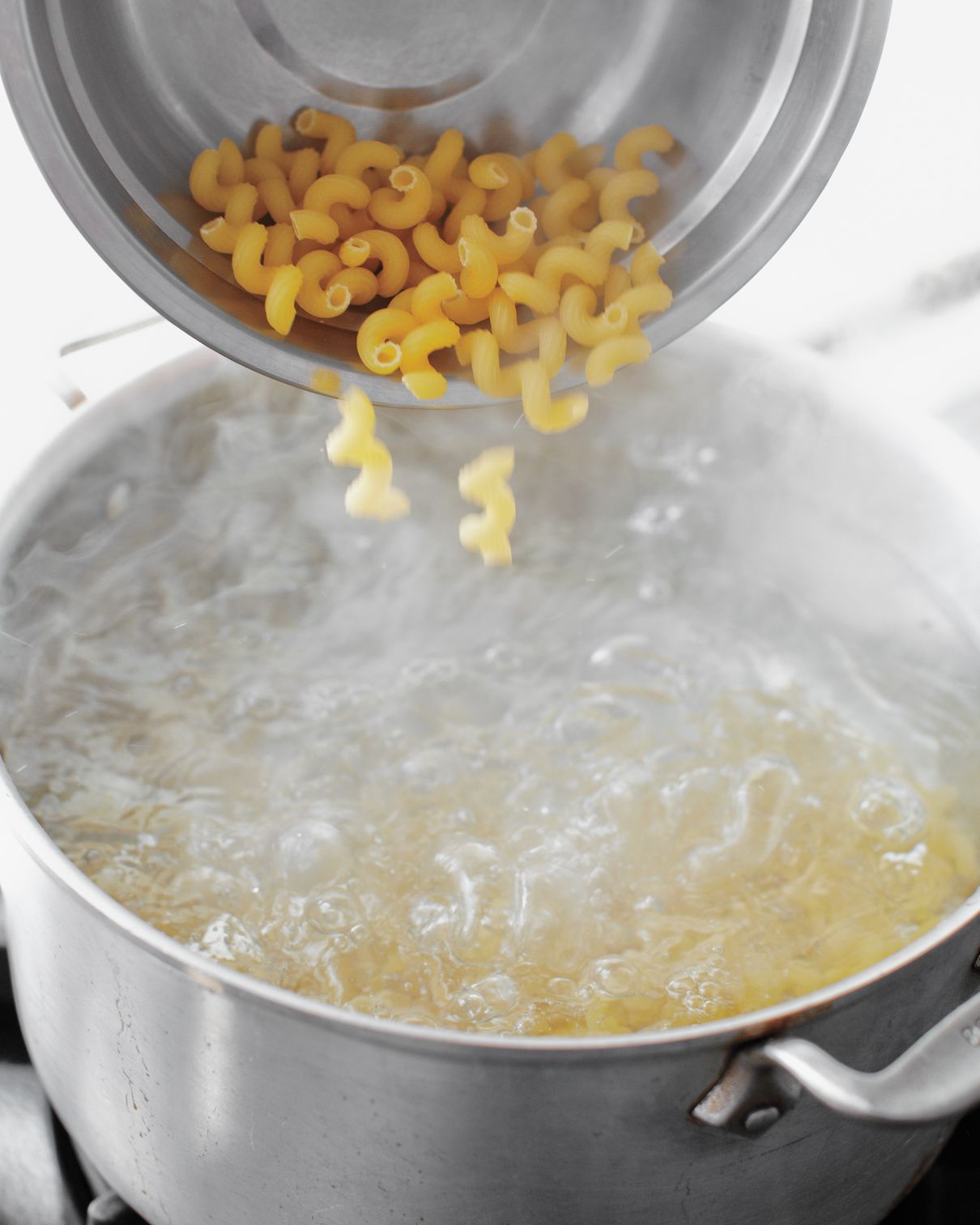 pasta going into pot of boiling water