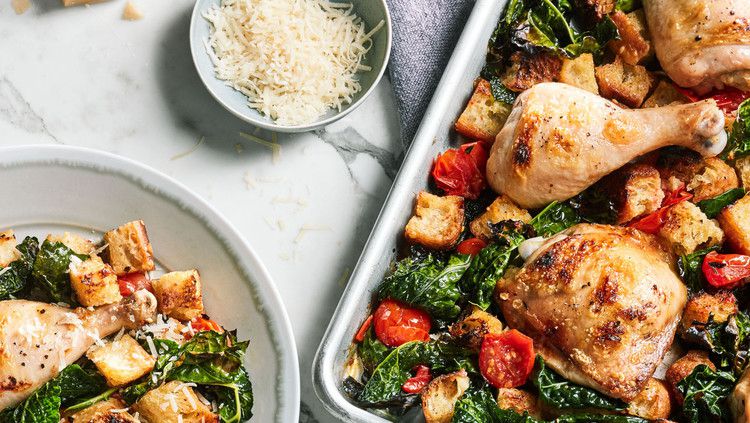 plate and sheet of chicken and kale dinner on marble table top