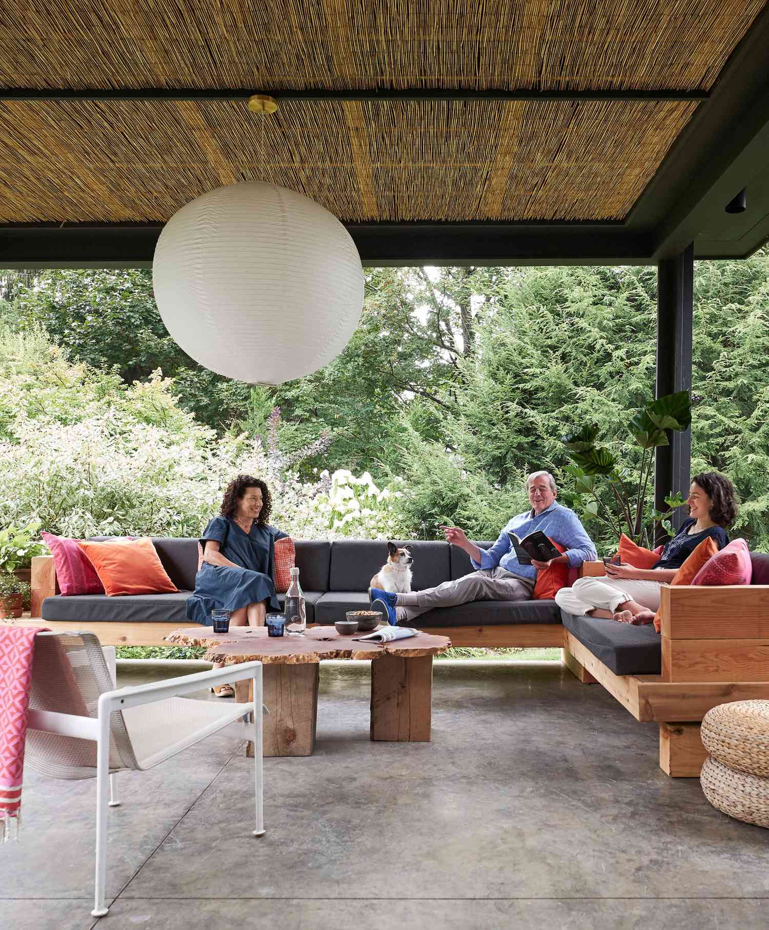 back porch with sectional couch globe light