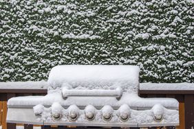 Snow covered barbeque grill during a snow storm