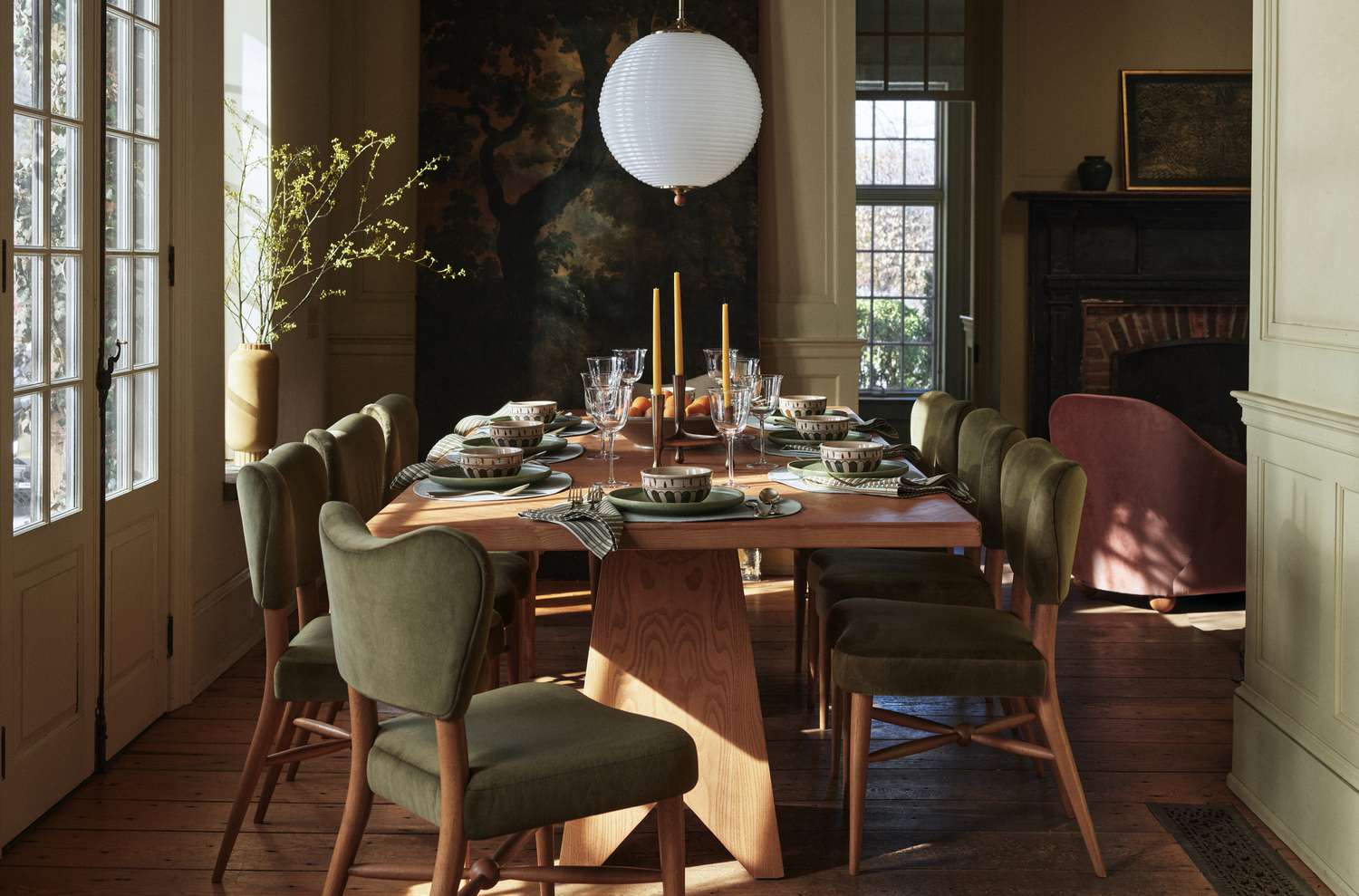 A dining room with green upholstered chairs 