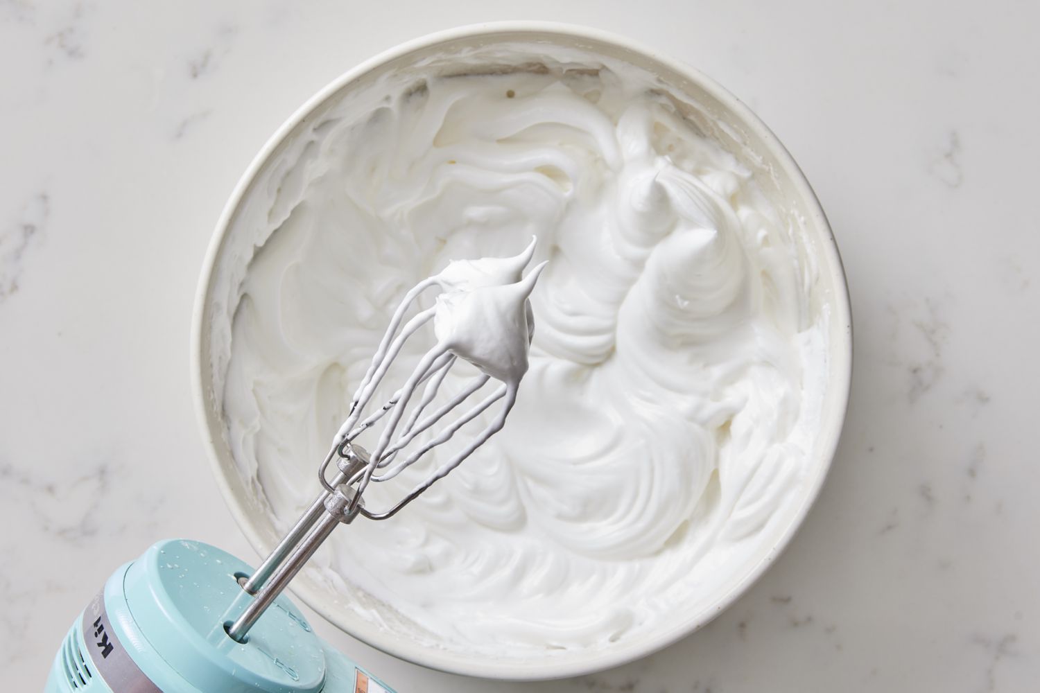 Egg white and sugar beaten in bowl