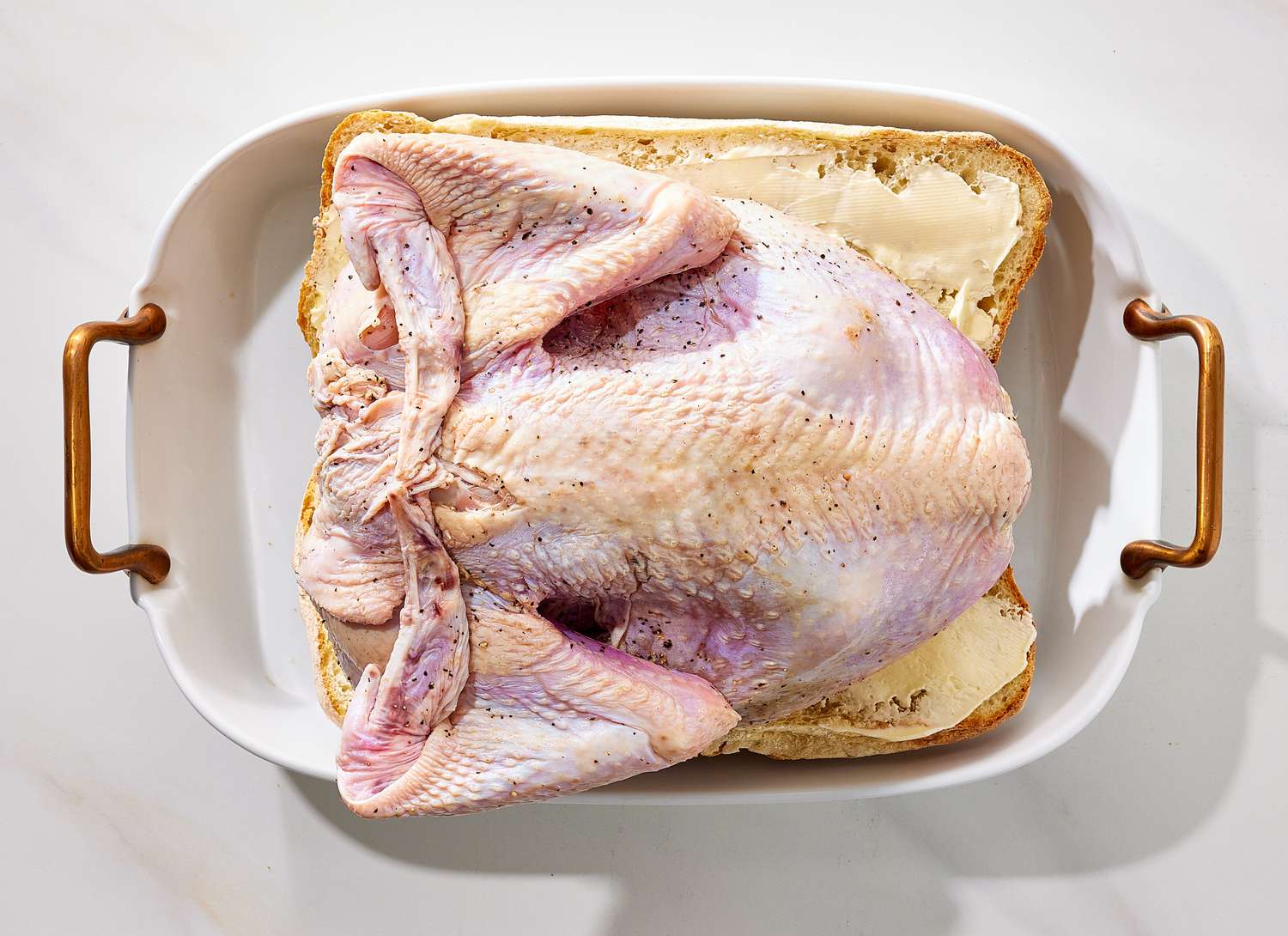 overhead view of raw turkey in a casserole dish
