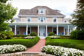 Home with lush grass and white flowers 