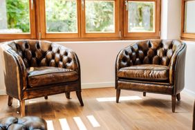 Two leather armchairs positioned in a sunlit room