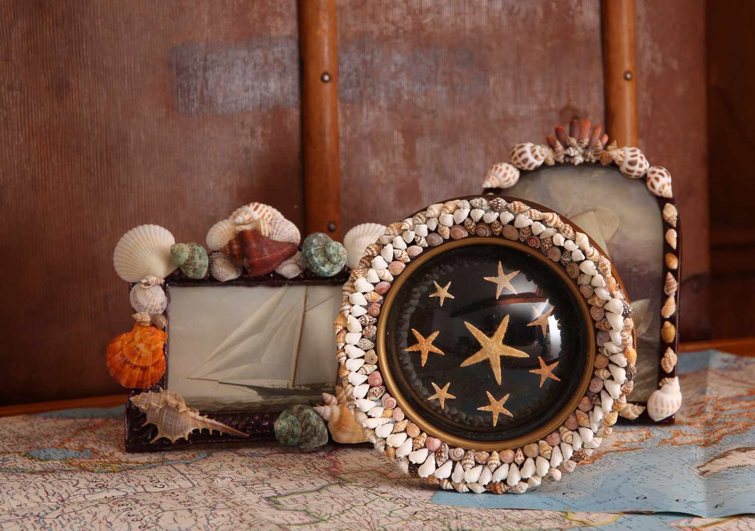 Decorative seashell-framed pictures arranged on a table