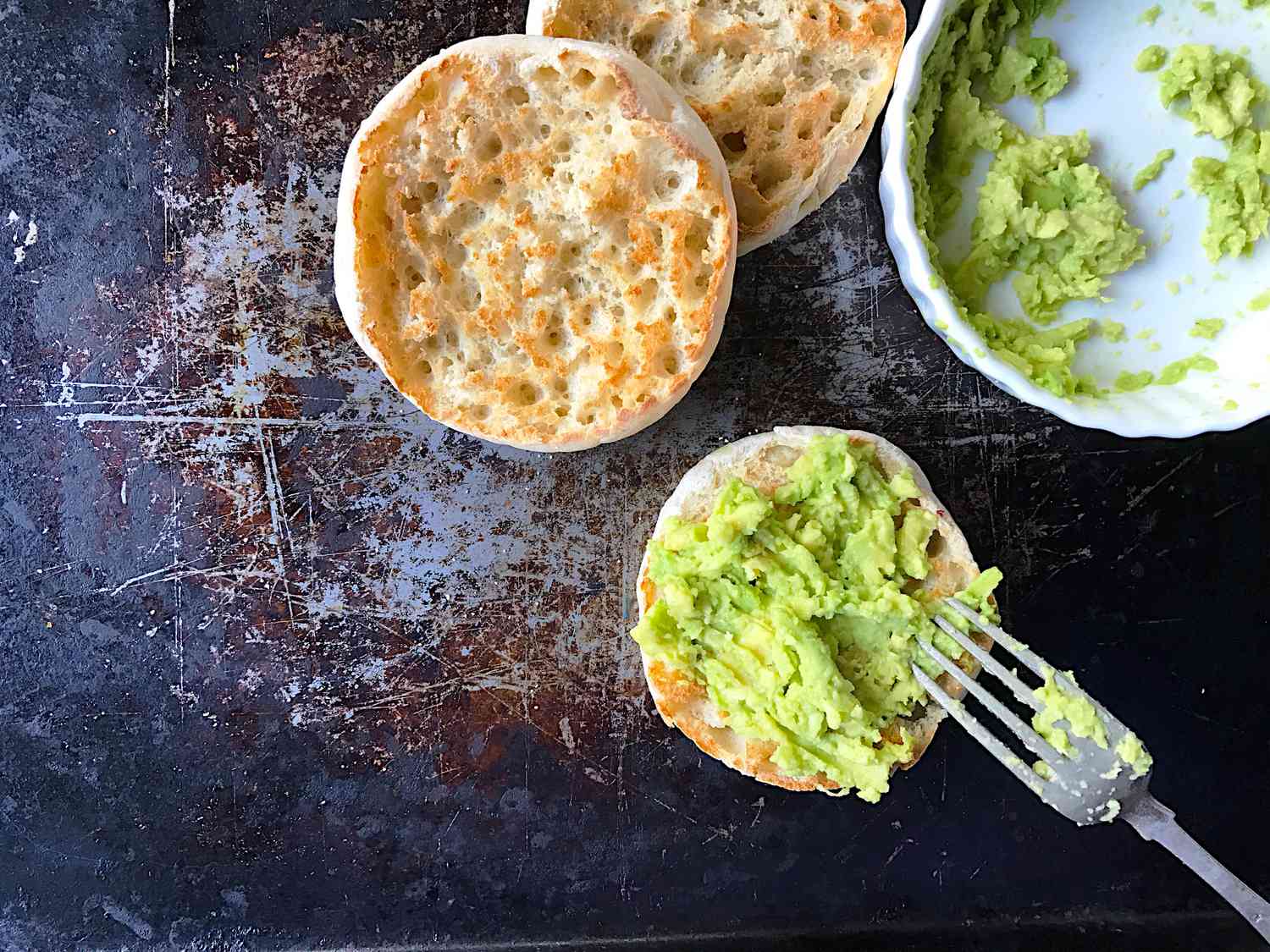 mashed avocado on a toasted English muffin