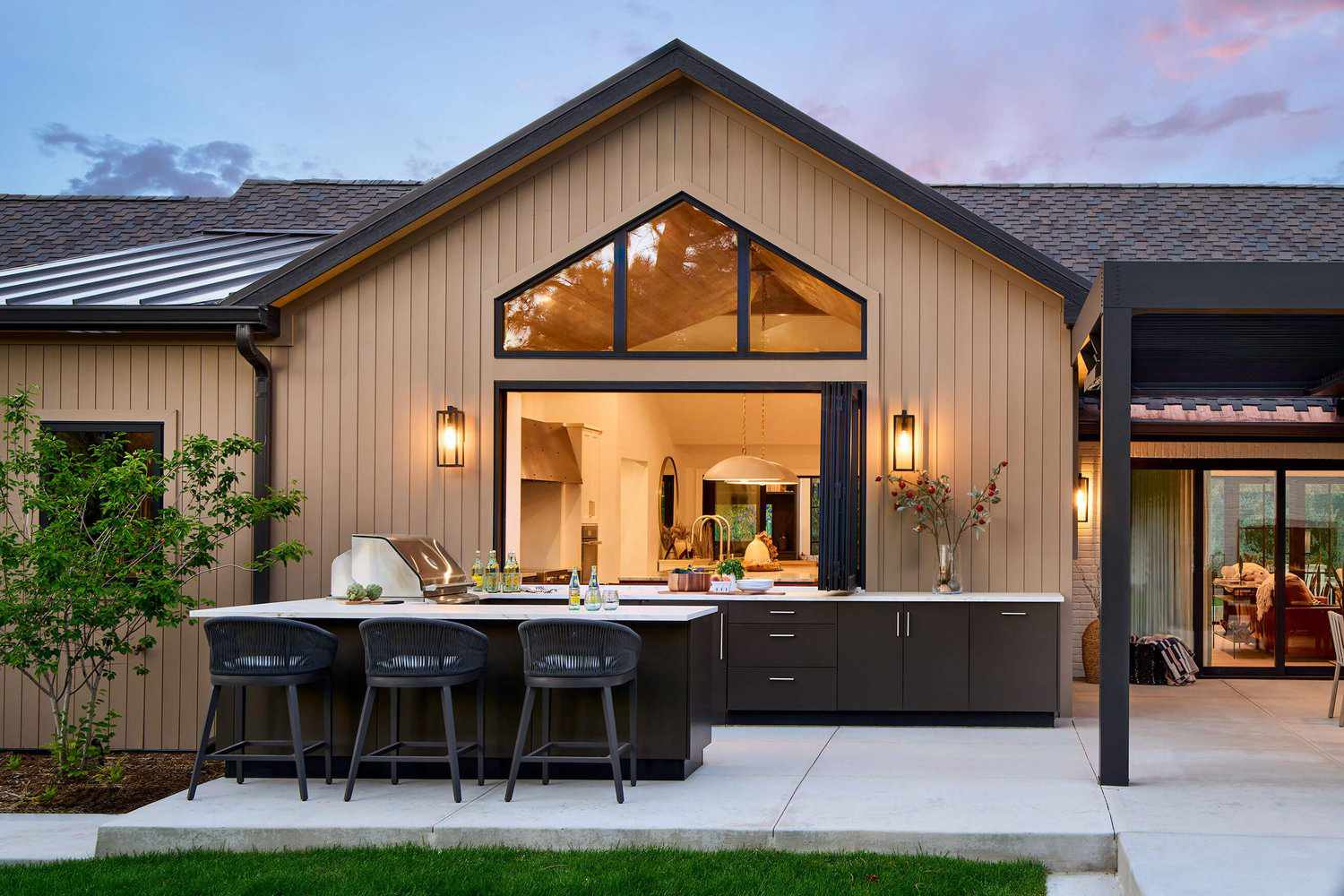 a U-shaped outdoor kitchen with dark cabinetry