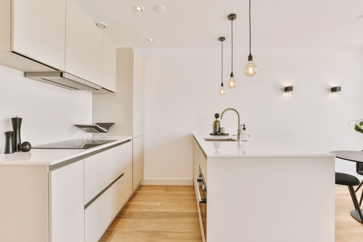 A small kitchen with a white interior and parquet floor in a cozy house