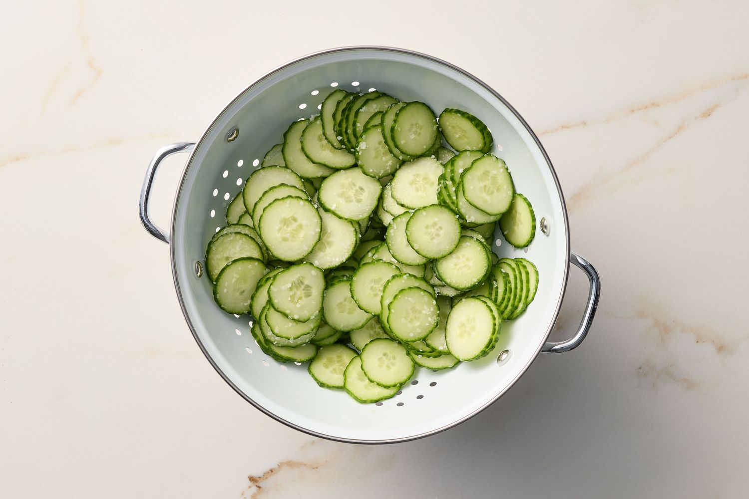 Sliced cucumbers in a colander