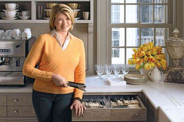 decorvow in orange sweater standing in kitchen