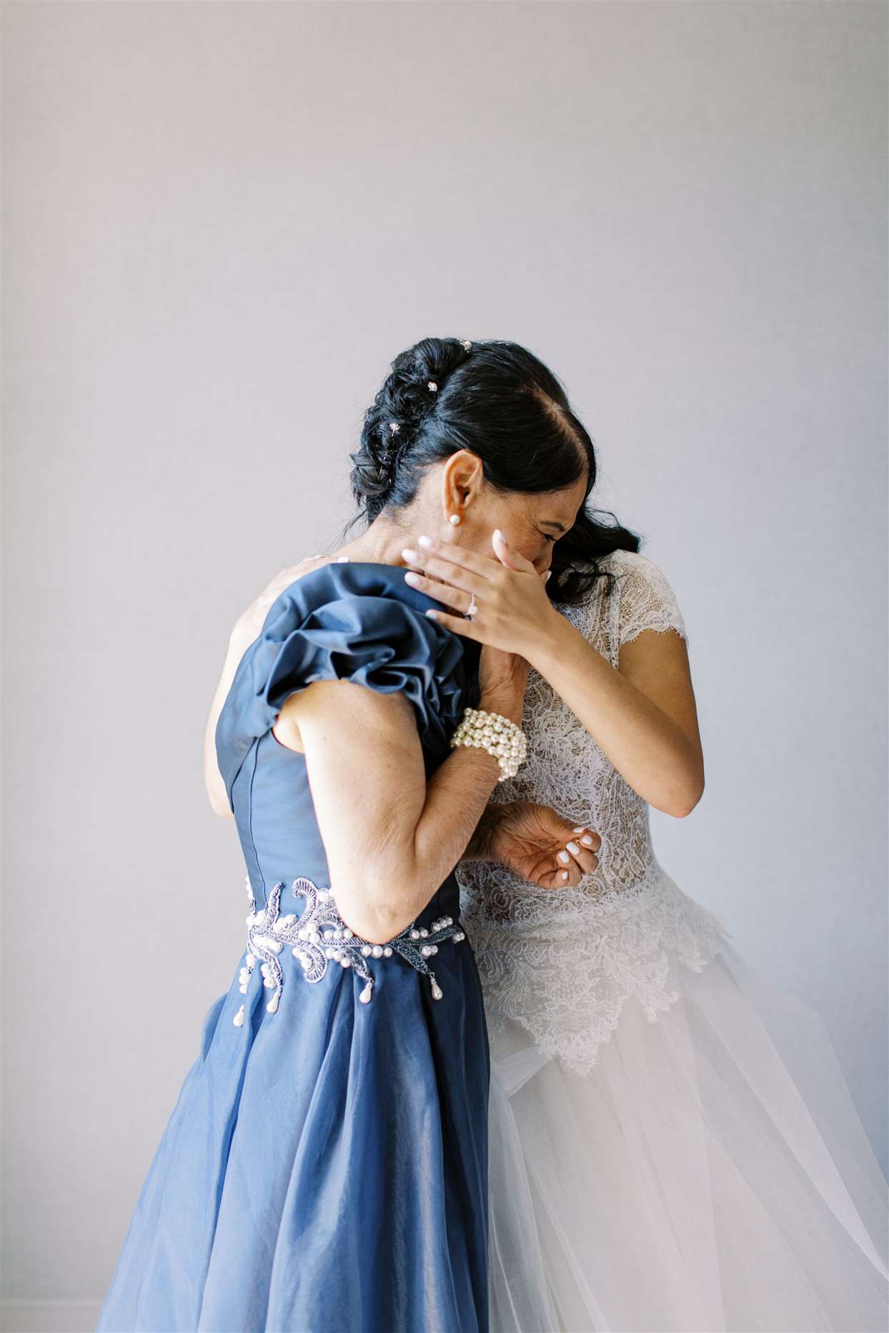 mother of bride embracing bride