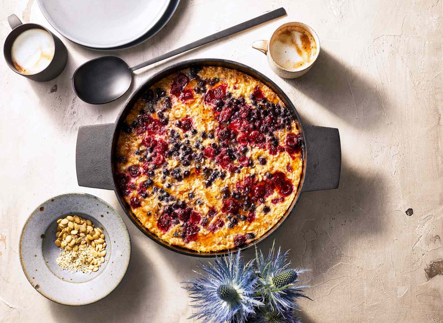 baked oatmeal with berries and seeds in a round pan 