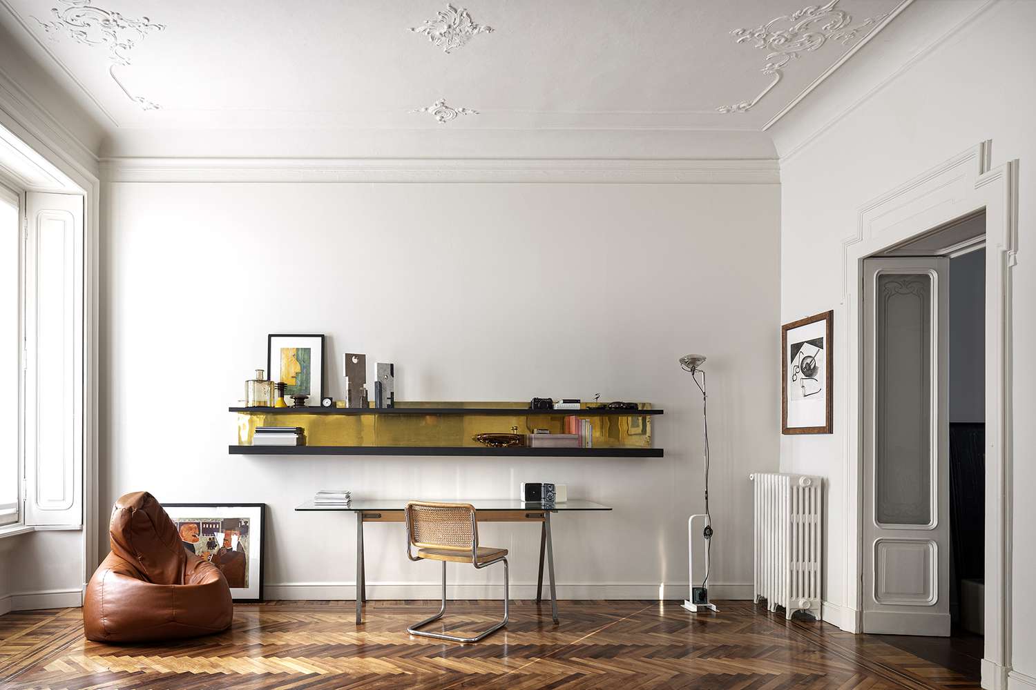 desk with floating black and gold shelves above