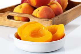 fresh peeled halved peaches in bowl