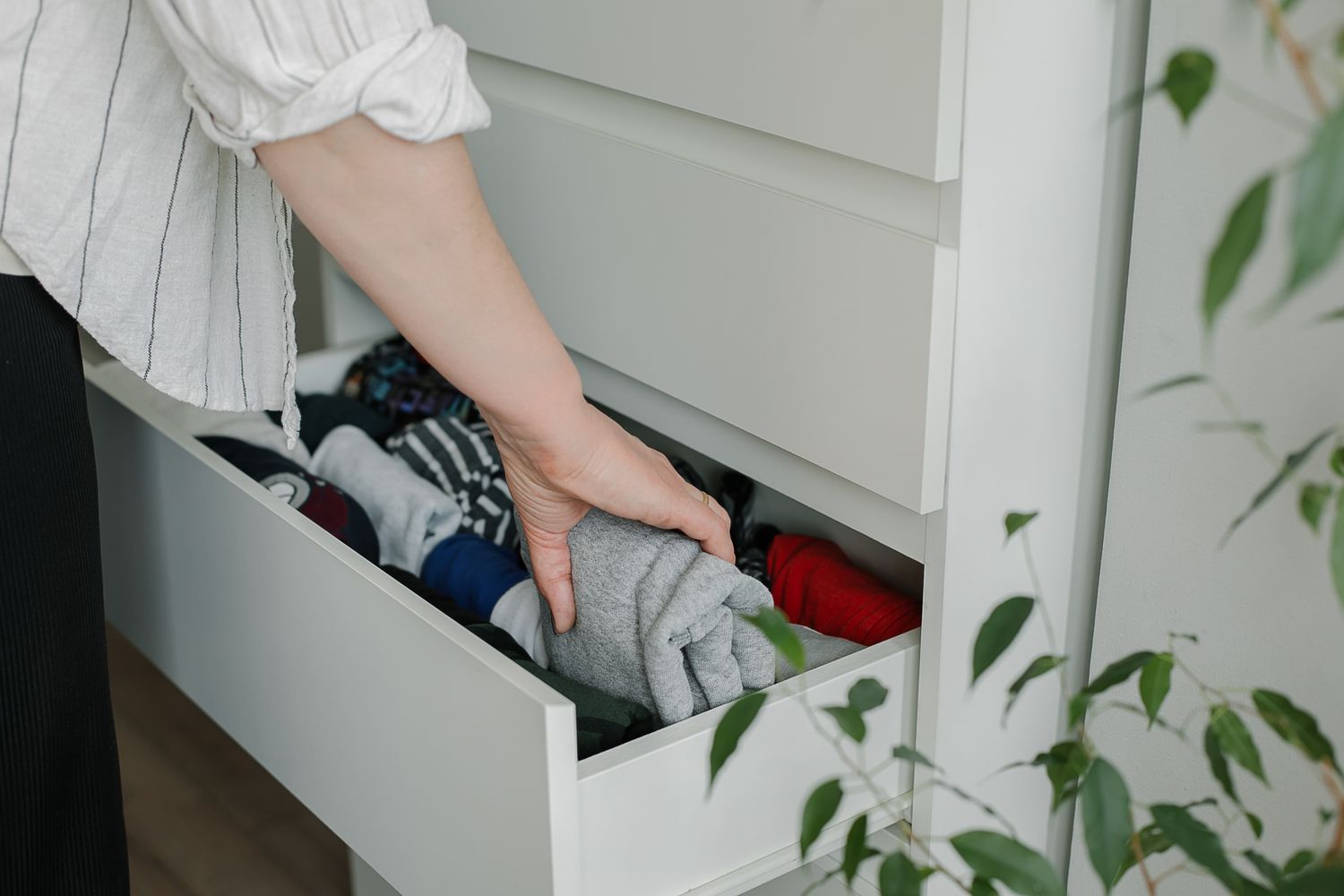 Woman organizing drawer of clothing