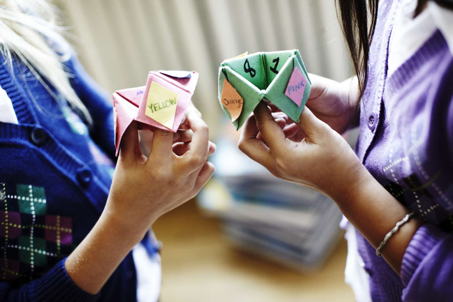 Two women playing with cootie catcher game