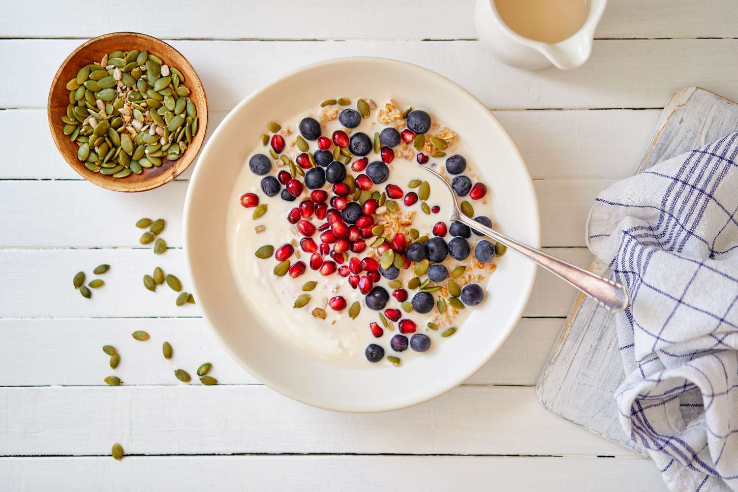 Granola with blueberries, pomegranate and pumpkin seeds together. 